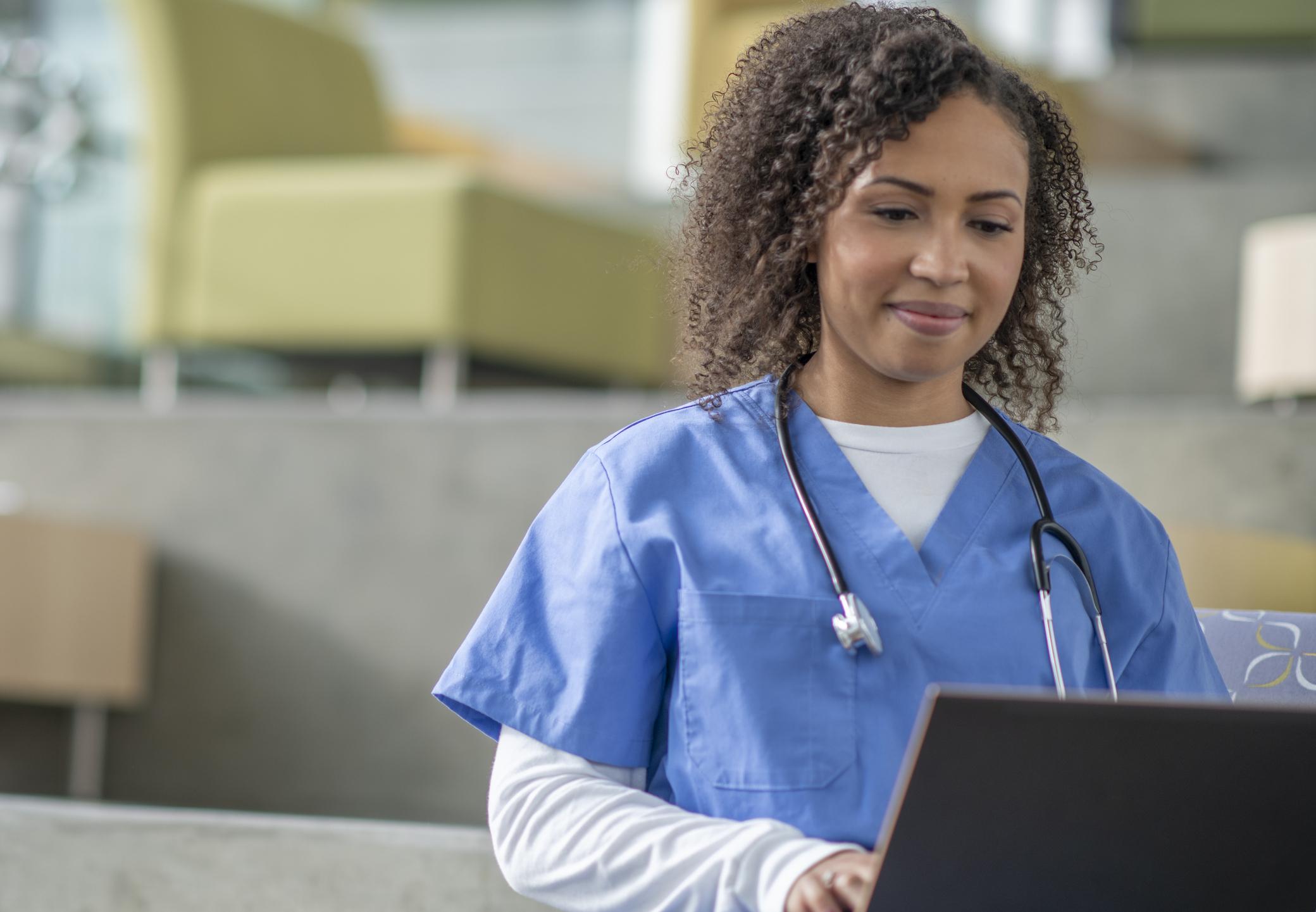 Nurse typing on laptop